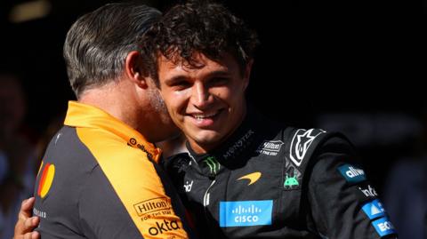 Lando Norris embraces McLaren CEO Zak Brown after taking pole position for the Spanish Grand Prix