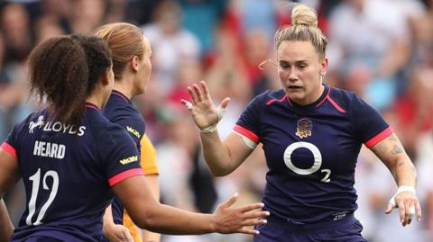 Meg Jones celebrates her try