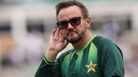 Mike Hesson cups his ear during a training session with Pakistan's Test side during their tour of England